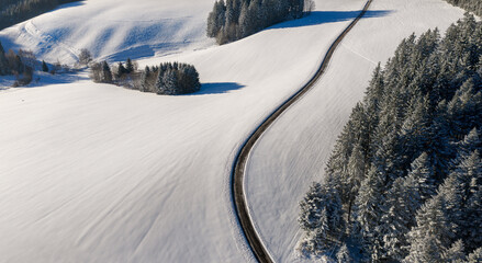 Winter road through the snowy Black Forest, in Germany, drone aerial  view