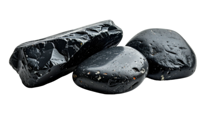 Close-up of glossy, dark stones, showcasing textures and variations, isolated against black