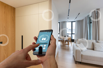 Home temperature, safety and environment control on mobile app. Smart phone in woman hand. Living...