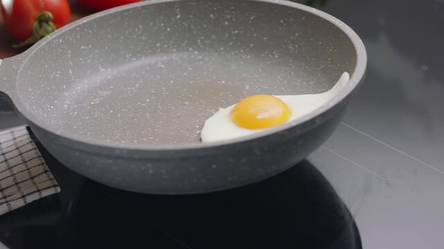 Process cooking egg on a frying pan for cooking sunny side up fried egg.