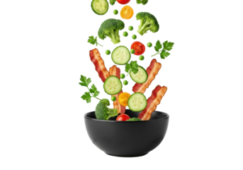 Vibrant broccoli, cucumber, cherry tomatoes, peas, parsley, and bacon falling into sleek black bowl on white background, energetic salad preparation concept.