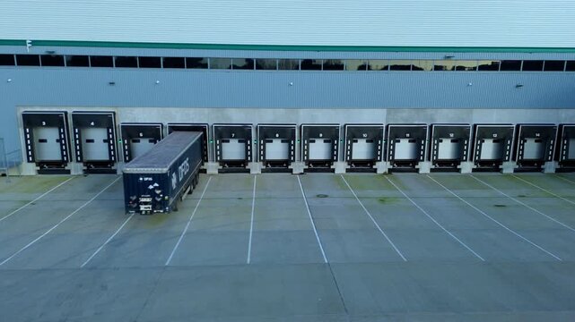Aerial view of loading bay with multiple doors, contrasting with the grey concrete, Kettering, United Kingdom.