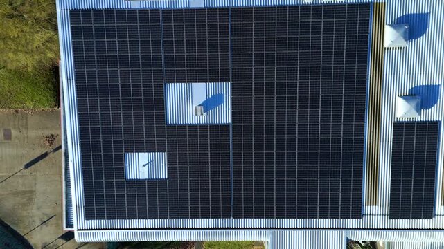 Aerial view of solar panels atop Nene Business Centre, displaying a pattern against the metal roof, Irthlingborough, United Kingdom.