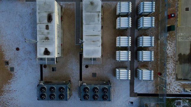 Aerial view of CNG cooling turbines and fans, the industrial landscape shows cooling units, fans, and neatly arranged cylindrical objects, Corby, United Kingdom.