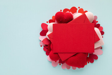 Saint Valentine or Mother's Day blue background with red envelope, paper card blank and various...