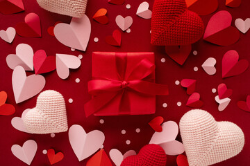 Valentine day gift box decorated with pink and red love hearts top view. Beautiful festive...