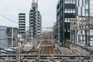 Dense modern city infrastructure with railway line and power cable in Japan