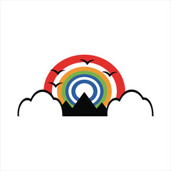 Colorful rainbow arching over mountains with silhouetted birds in flight