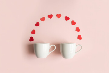 Two coffee cups and red wooden hearts on a pink background. The concept of Valentine's day, love, dating and wedding. Symbol of a romantic gift or marriage proposal. minimalism. 