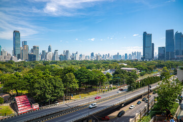 City road with modern office building green tree public park