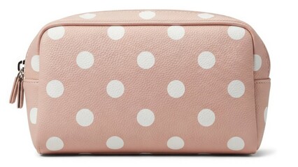 Beige polka dot cosmetic bag with soft fabric texture isolated