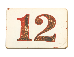 Vintage distressed house number 12 sign plate with rust patina and worn typography label cutout on isolated background