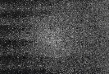 Dark black grunge bumpy textured surface background