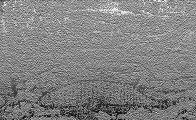 Rough, grainy gray texture creating an abstract surface background
