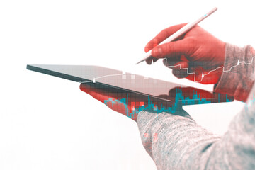 Silhouette of professional using tablet device with stylus combined with red blue teal financial charts and digital grid patterns. Innovation visualization and business analytics.