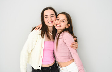 Two cute and Young pre teen girl on studio white