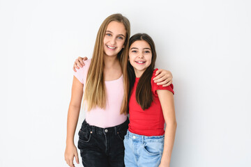 Two cute and Young pre teen girl on studio white