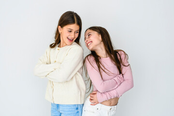 Two cute and Young pre teen girl on studio white