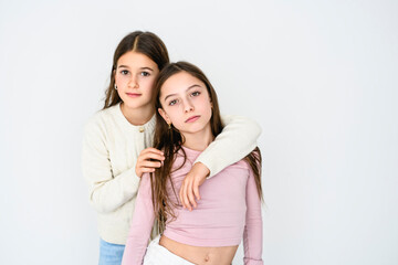 Two cute and Young pre teen girl on studio white