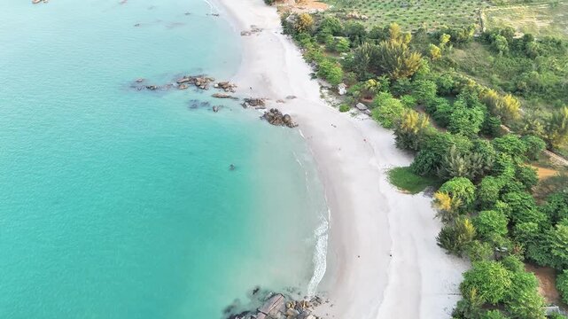 Aerial View of Rocky Tropical Beach with Turquoise Sea and White Sand