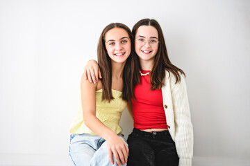 Two cute and Young pre teen girl on studio white