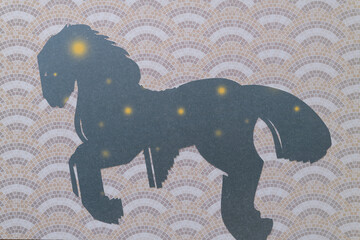 abstract machine-cut equine shape on decorative paper with pavement pattern