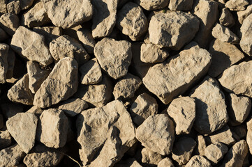 Many rocks stacked on river side.