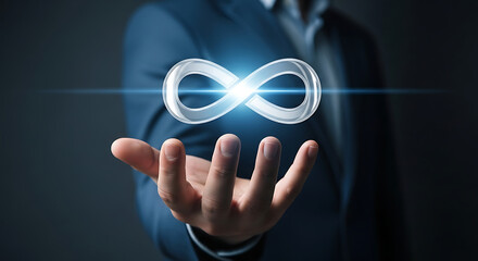 Infinity symbol held in hand business concept connection infinite loop silver
