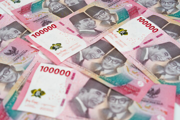 Indonesian 100 thousand rupiah banknotes background showing national currency, finance concept, cash money pattern for economy, business, investment, and financial design