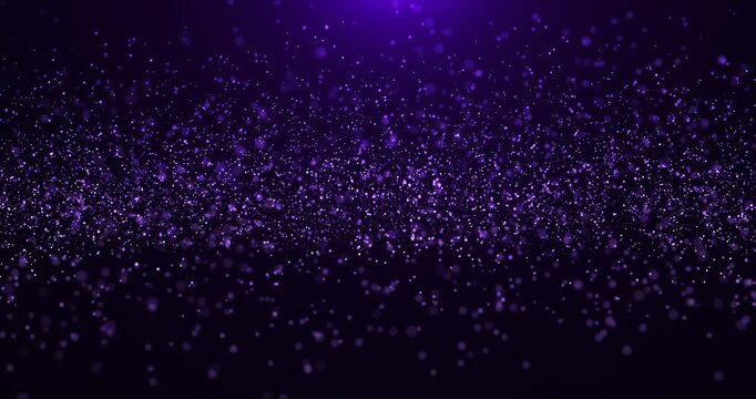 Abstract animated concept of purple particles for celebrating birthdays and holidays. 4k loop with bokeh background and glowing particles on a dark background. Seamless loop