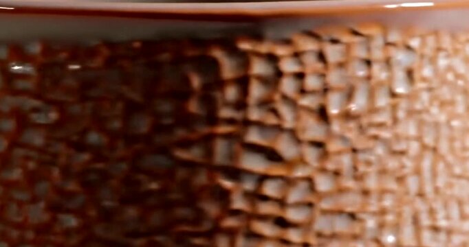 Close up of a textured copper surface with a gradient effect.