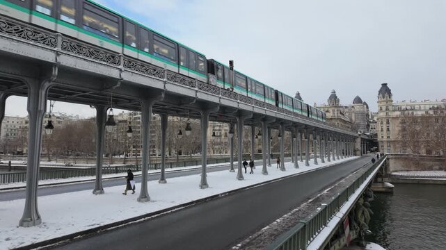 Metro on Bir Hakeim bridge in winter with snow