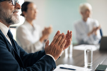 Business people clapping hands in a successful meeting