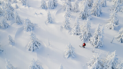 Beautiful Winter Mountain Scenery with Man on Cross-Country Skis , Aerial View