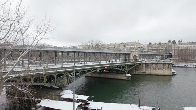 Metro on Bir Hakeim bridge in winter with snow