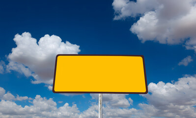 Yellow blank road sign against blue sky with white cloud, created for drivers, designers, and advertisers to add custom warning, traffic guidance, or public safety messages