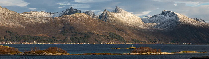 Panoramic view to the Nordfjorden with winter mountain range on the isle of Senja.