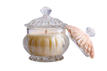 Elegant clear glass jar candle with a decorative fluted design and a partially open lid revealing a seashell accent, set against a white background.