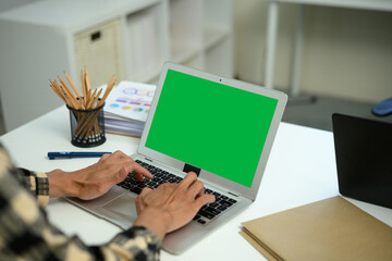 Closeup man using laptop green screen isolated on meeting table
