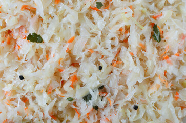 Background with fermented sauerkraut with carrots and spices