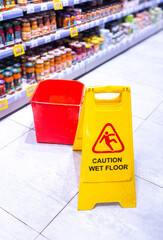 Caution Wet Floor yellow warning sign in a superstore