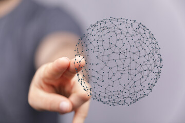 Human hand interacting with a digital network sphere. Concept of global connection, internet, modern technology and innovation. Data transfer an