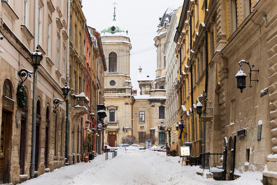 Beautiful winter view of the old city street with historic architecture and snow