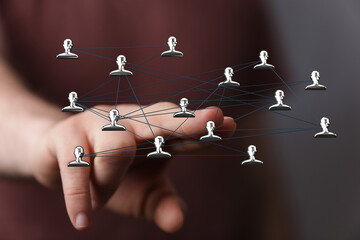 Hand reaching towards a network of connected people icons. Represents connections, communication, and digital interaction. Great for business an