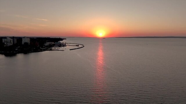 Golden sunset over the Parana River and Posadas costanera. Stunning orange sky and river view in Misiones, Argentina.