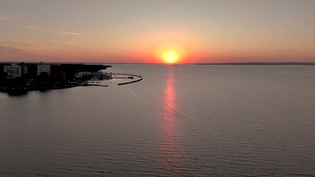 Golden sunset over the Parana River and Posadas costanera. Stunning orange sky and river view in Misiones, Argentina.