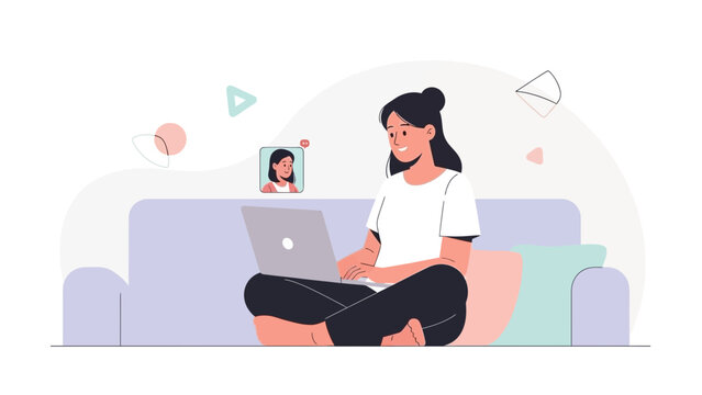 Young woman video calling on laptop while relaxing on couch at home