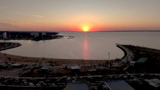 Golden sunset over the Parana River and Posadas costanera. Stunning orange sky and river view in Misiones, Argentina.