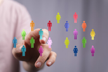 Abstract concept of digital human network, connections, and interaction visualized with colorful person icons on a finger. Ideal for business, s