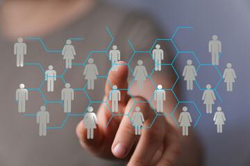 Close-up of a finger touching a digital human network. Illustrating teamwork, connections, and...